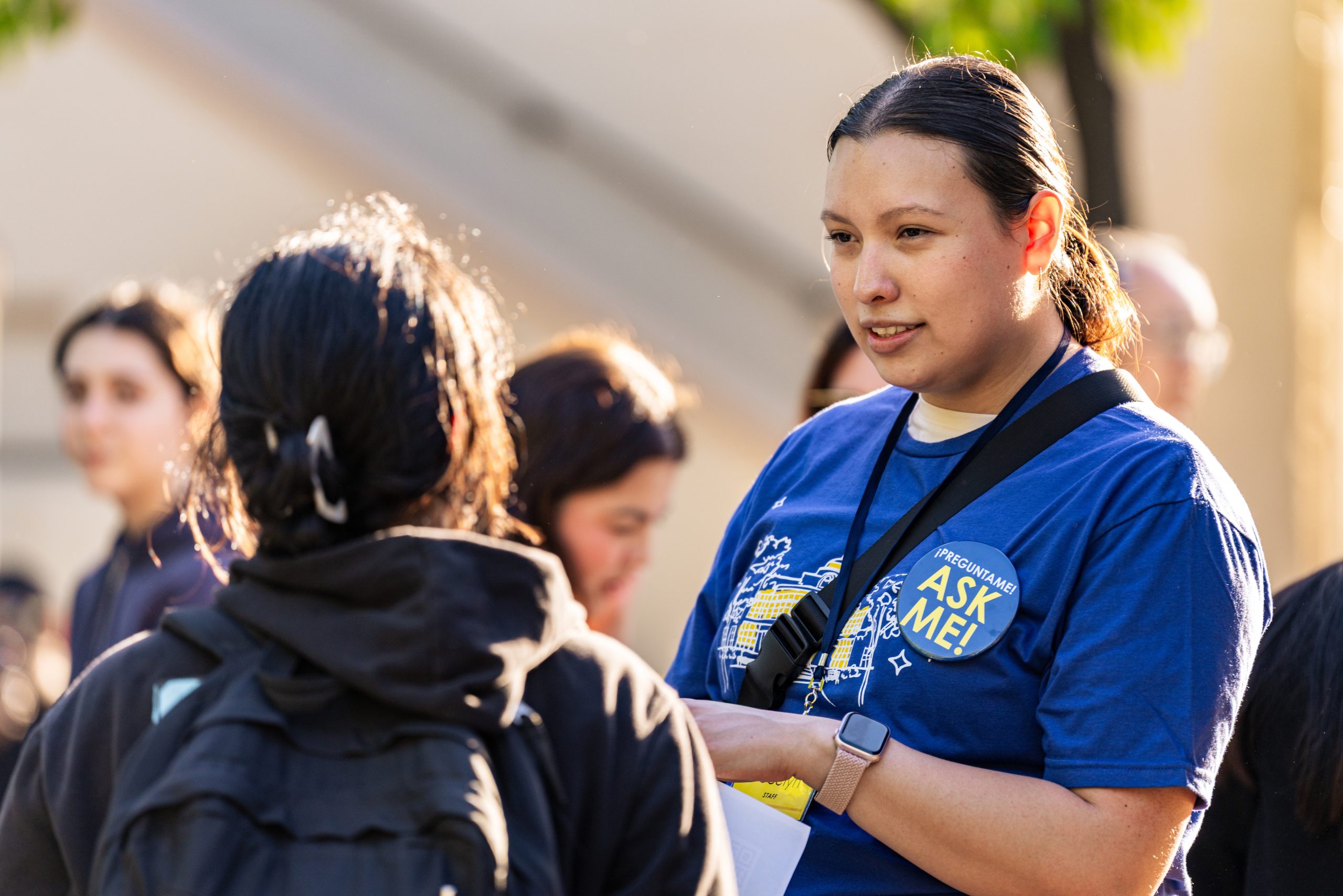 A female Fullerton College staff member assists a female student with a question.